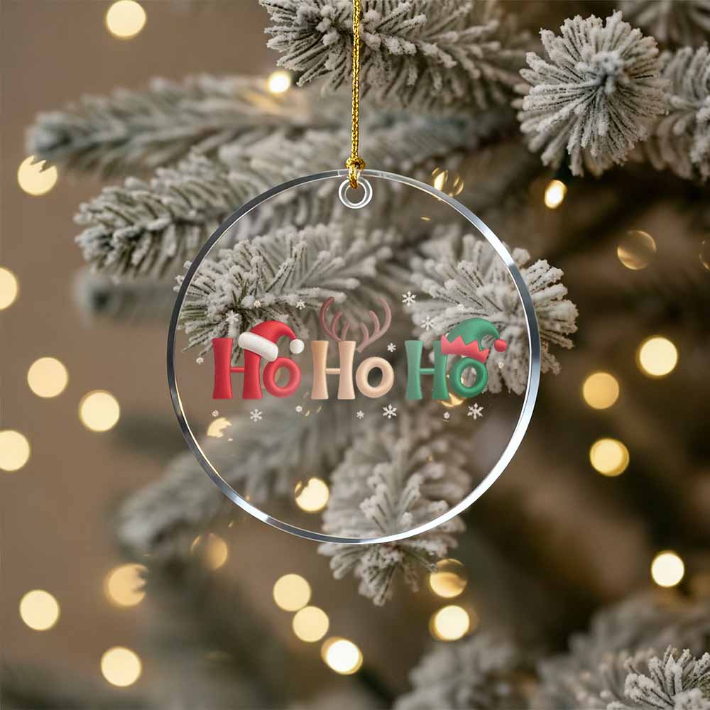 Decorative Christmas ornament with 'Ho Ho Ho' text on a tree with lights in the background