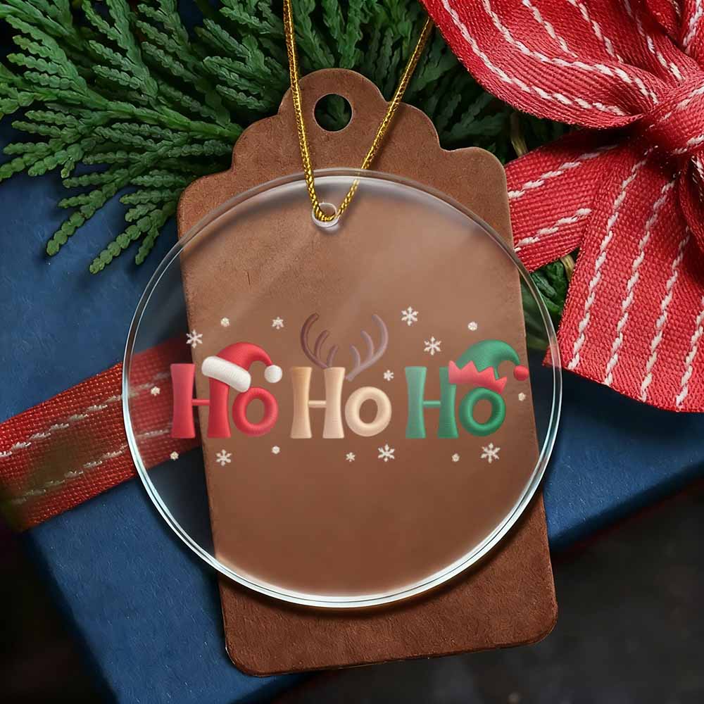 Christmas ornament with 'Ho Ho Ho' text on a brown tag, surrounded by greenery and red ribbon.