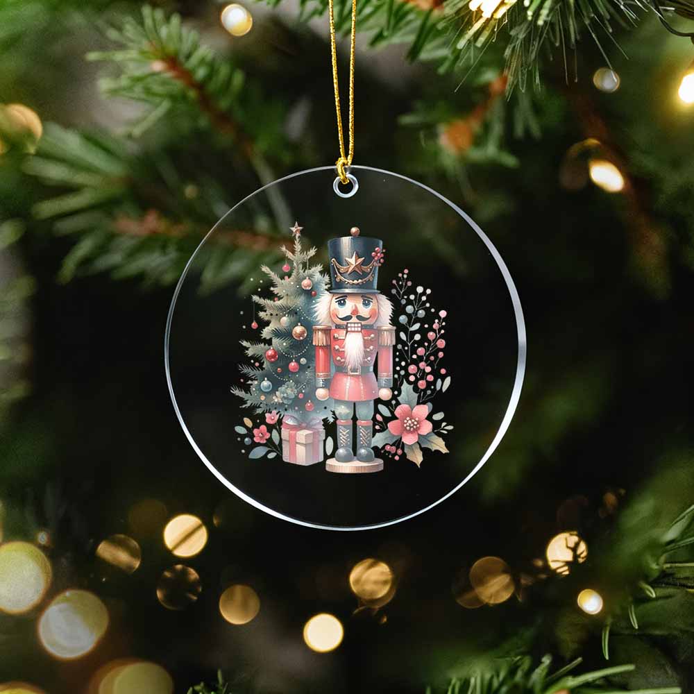 Decorative Christmas ornament with a nutcracker and tree on a green tree background.