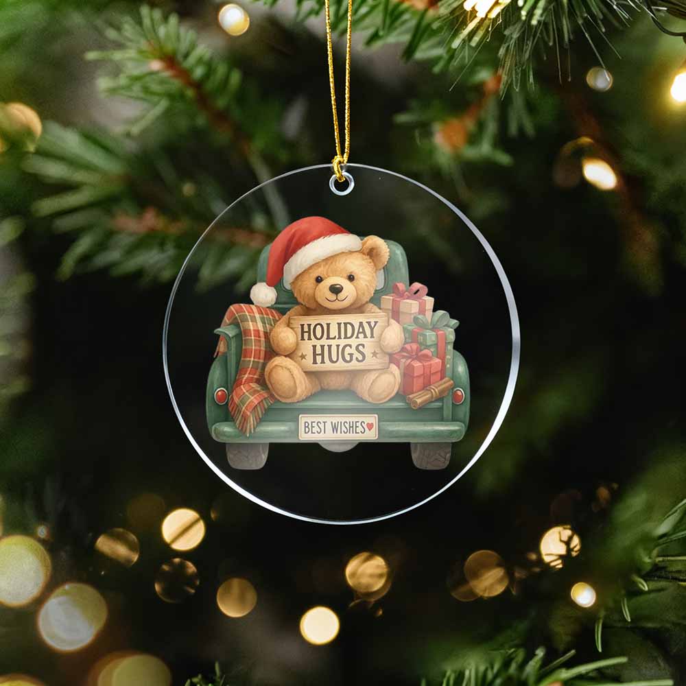 Christmas ornament with a teddy bear in a car and 'Holiday Hugs' text, hanging on a tree.
