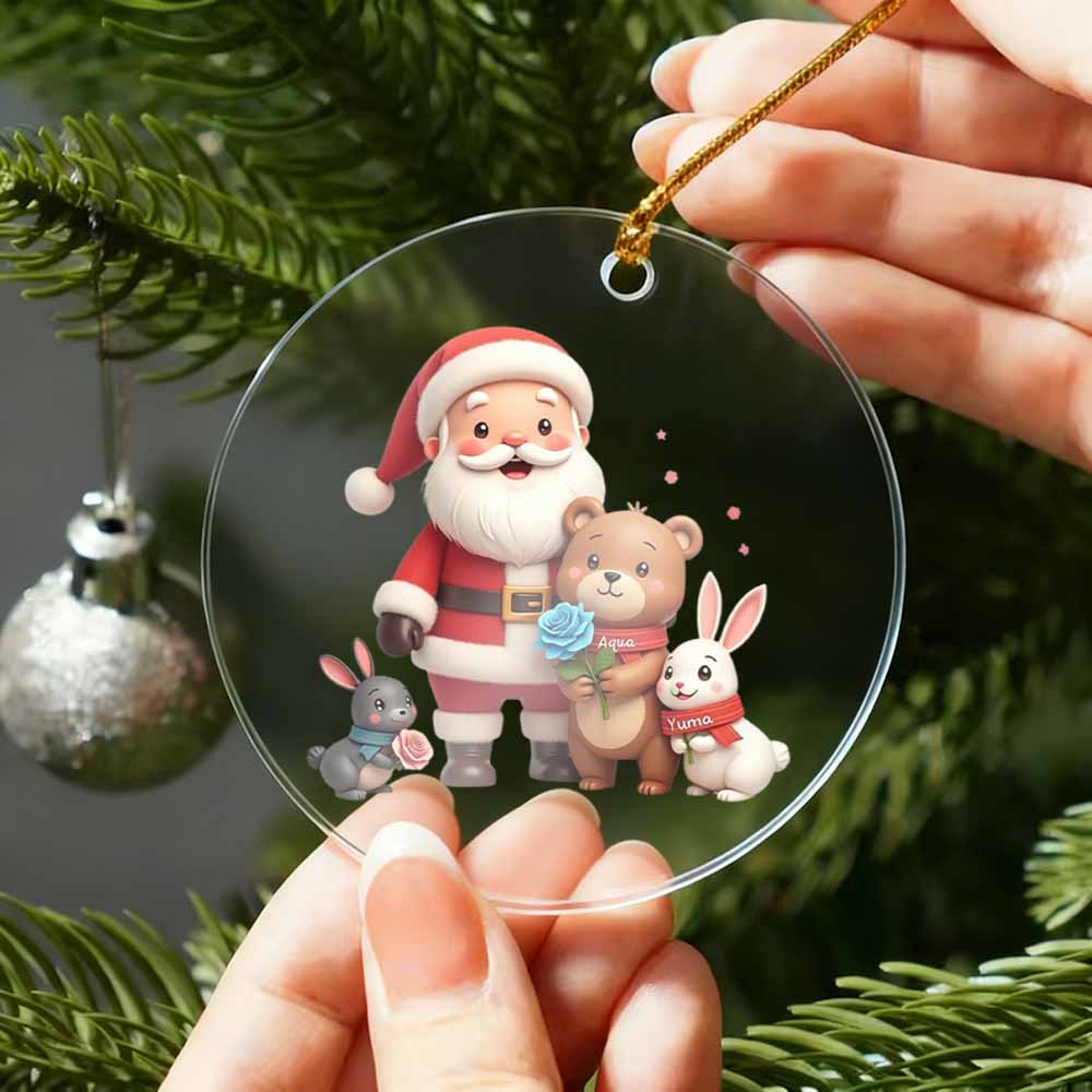 Clear Christmas ornament with Santa Claus and animals held by a person against a Christmas tree background.