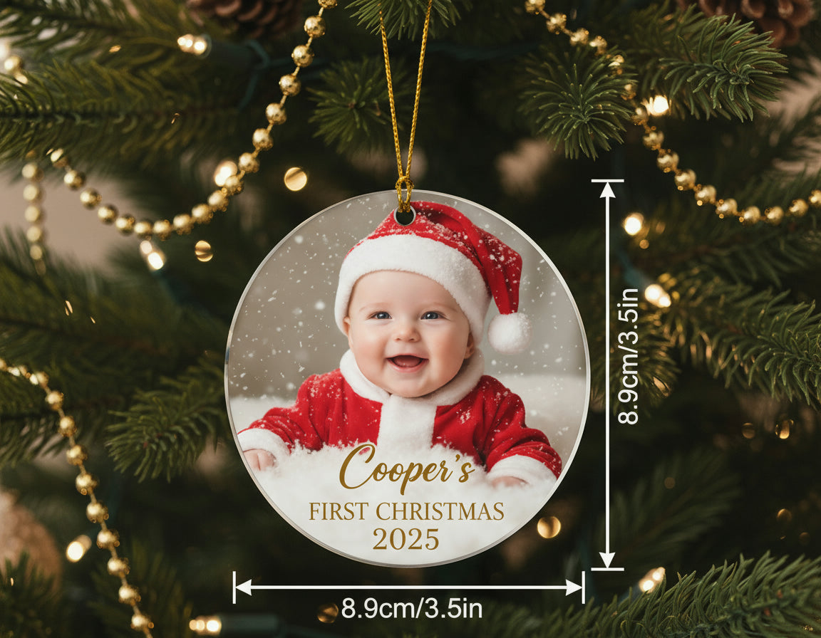 Ornament for Christmas ornament with a baby's photo and 'Cooper's First Christmas 2025' text, hanging on a decorated tree.
